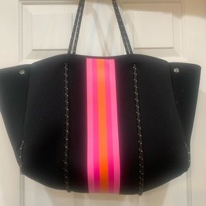 Haute Shore black neoprene tote with orange and pink stripes
